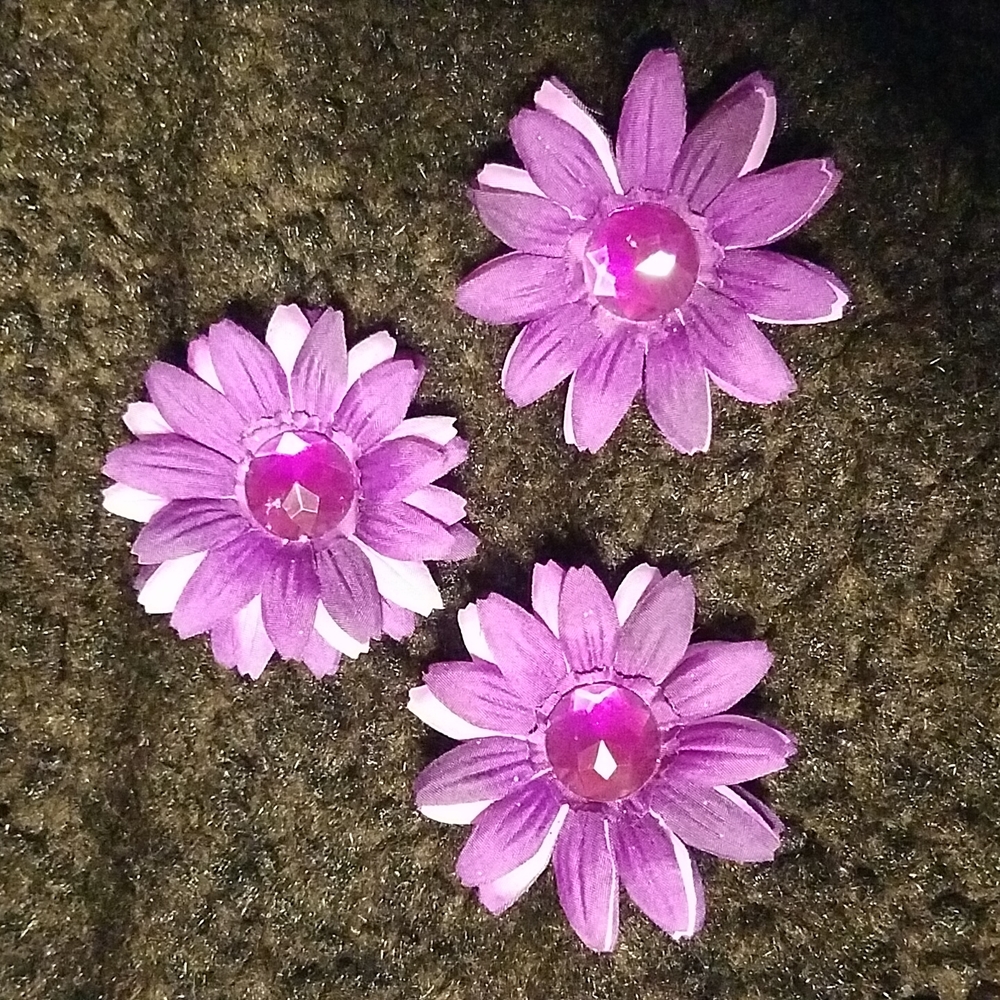 Three purple flowers with sparkly centers.  For decorating or crafting.